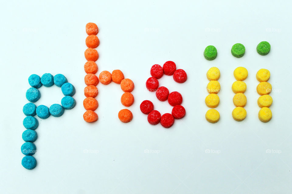 My photographer name, phsiii, is spelled out in sour,chewy gummies in shades of turquoise, orange, red, yellow & green; all on a white background. 😋
