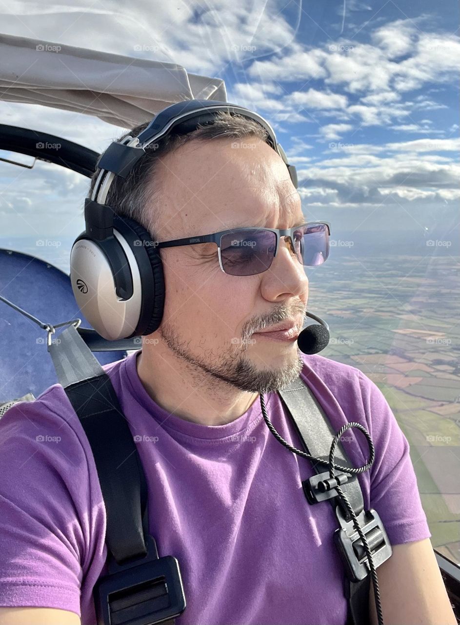 Nice man selfie portrait. Flaying in the sky. Man -pilot. Smartphone selfie man portrait. 