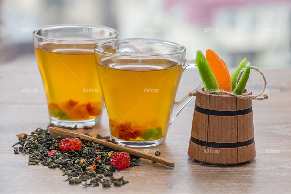 Dry tea leaves with cup of green leaves