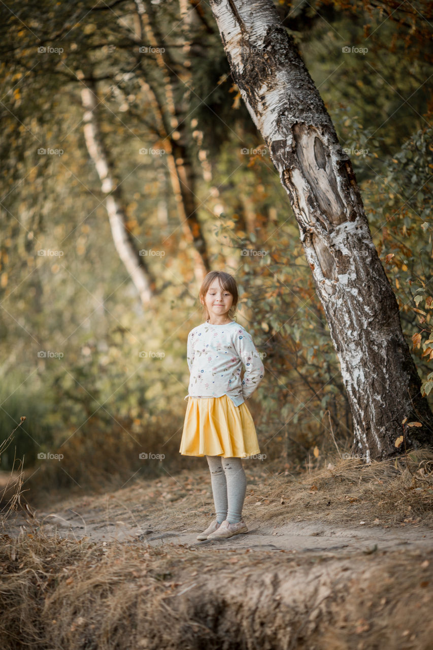 Little girl portrait at autumn day