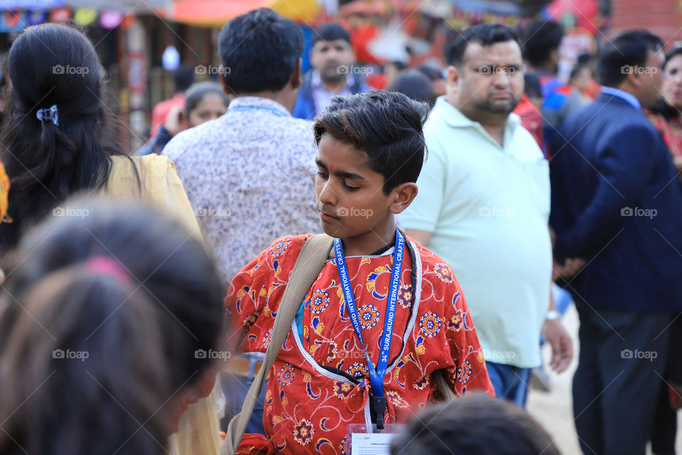 A kid playing drum at the surajkund international crafts fair