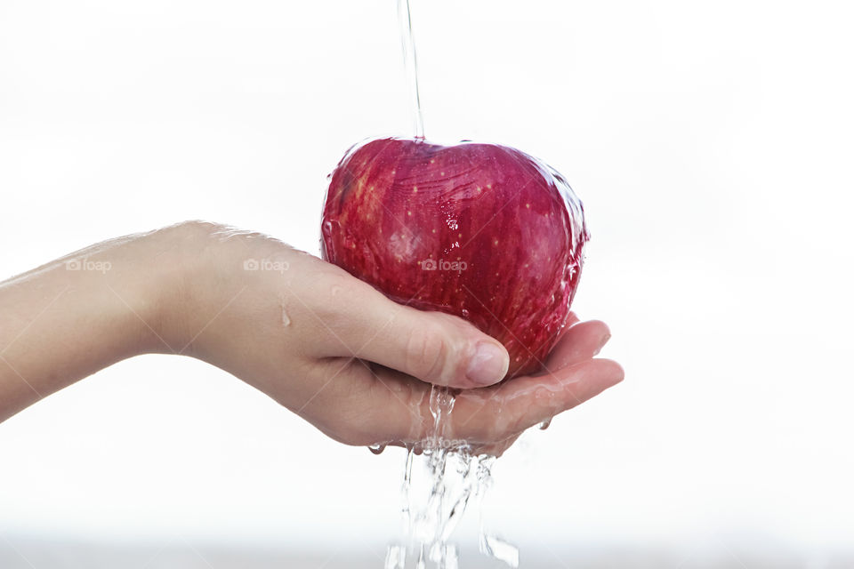 apple in the hand under the water