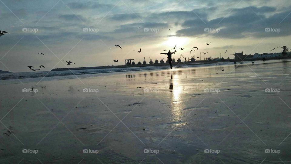 Happiness of man near the beach at essaouira city in morocco.