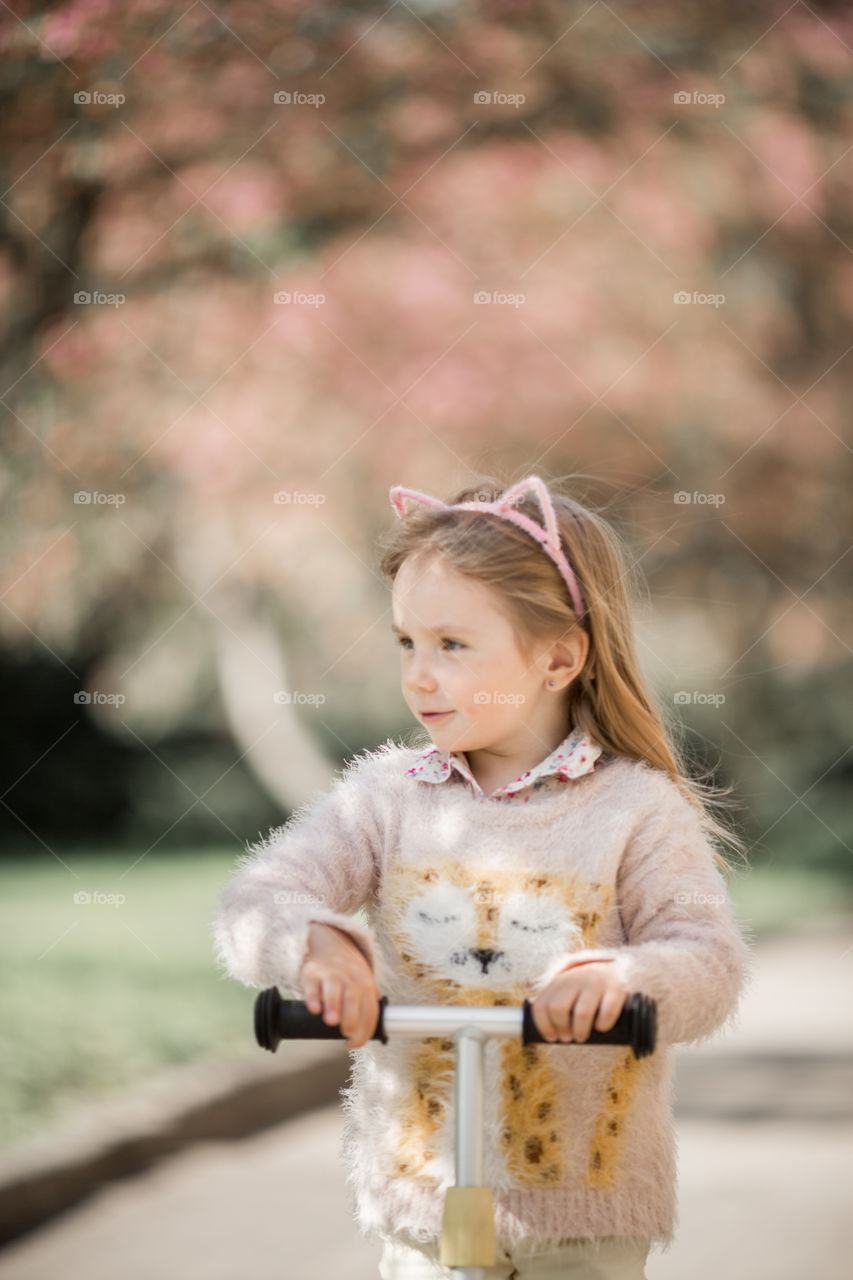 Cute Little girl in a blossom park