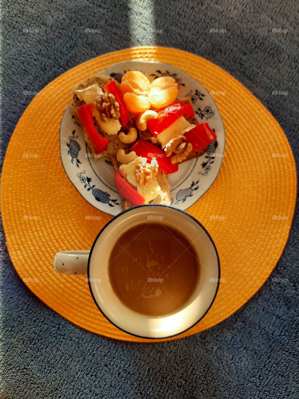 sun ray illuminating coffe  and a plate with breakfast