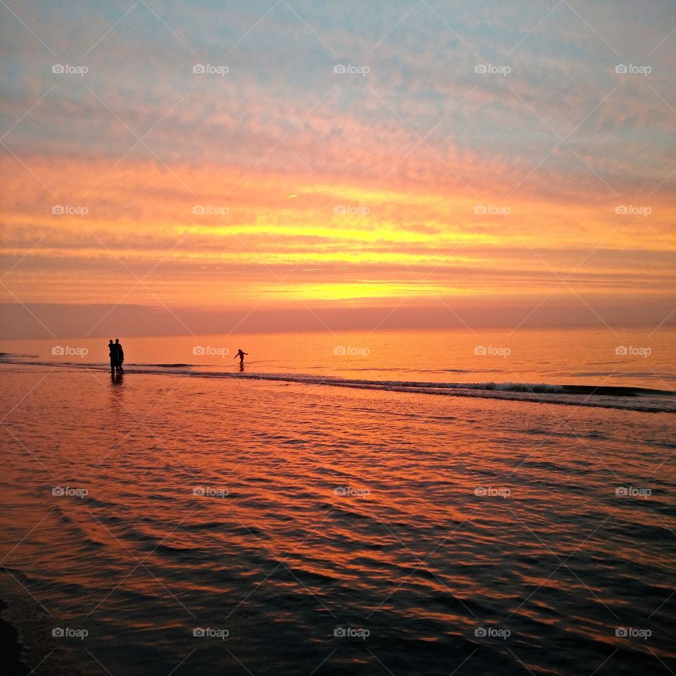 people having fun during beautiful sunset