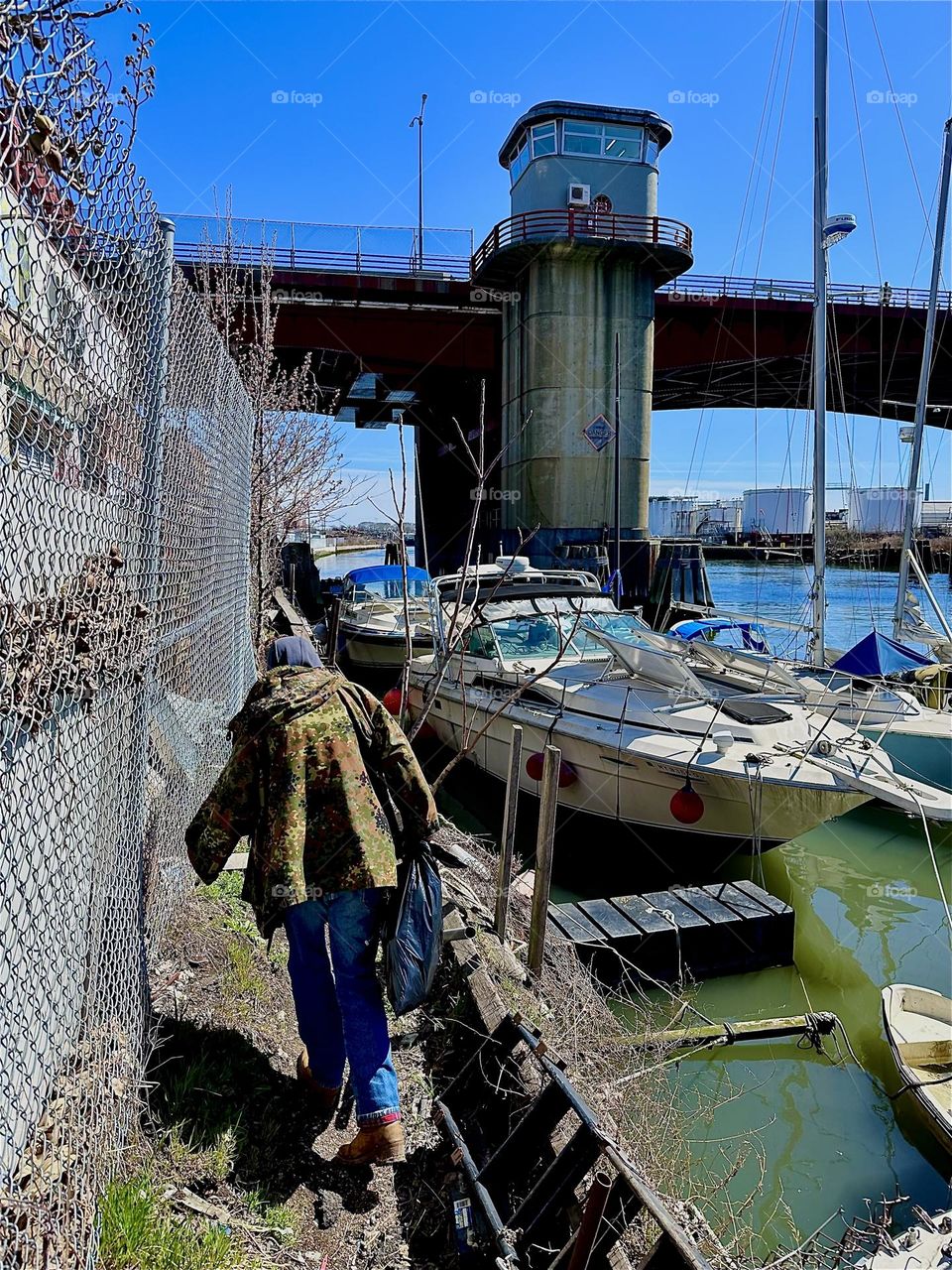 This is the narrow strip of land with the wooden planks that various boats are tied to at “Newtown Creek” by the “Pulaski Bridge” in LIC, Queens. 2024. Hypnotic Productions