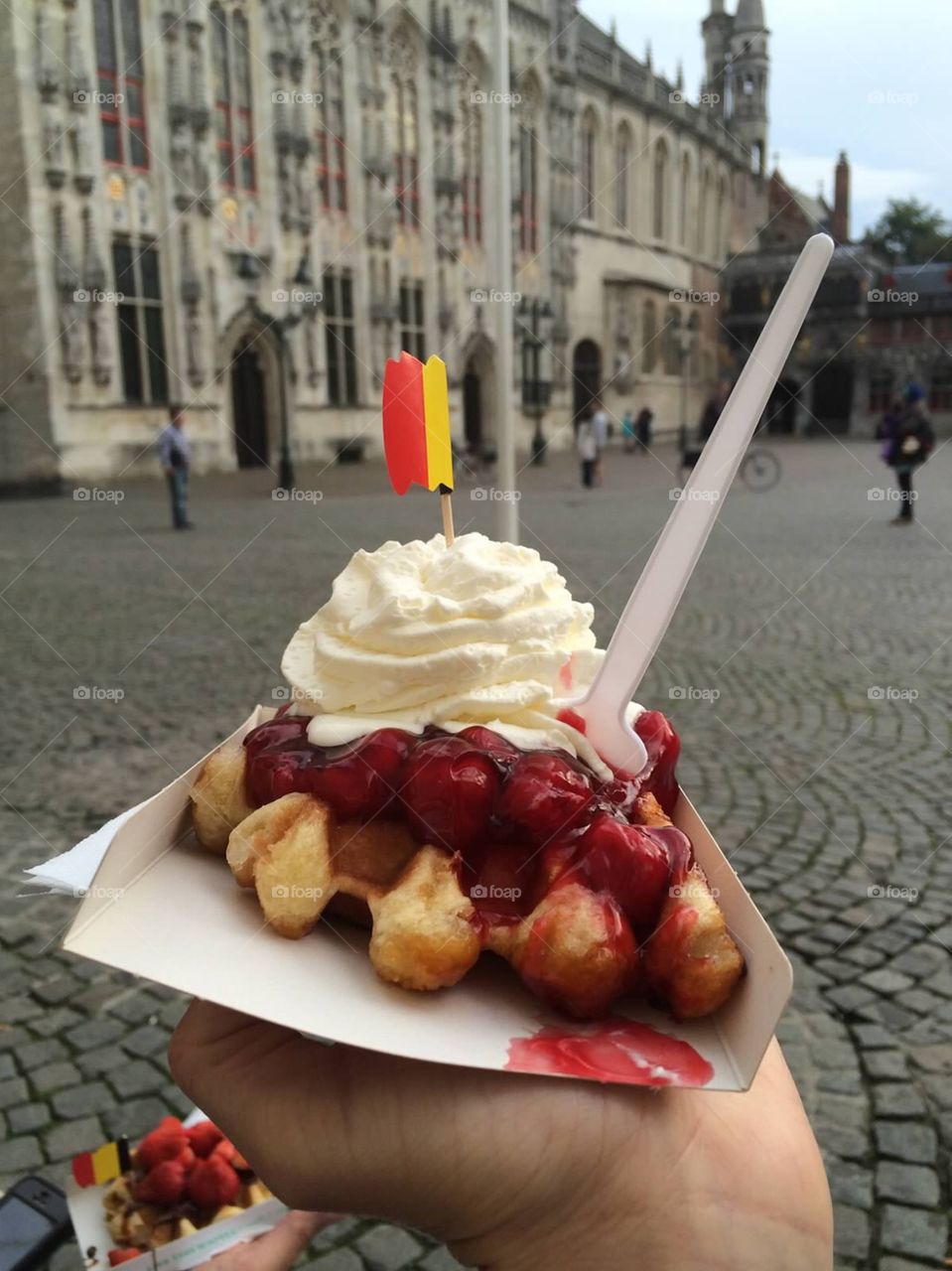 Belgian waffle. Eating Belgian waffles in Brugge 