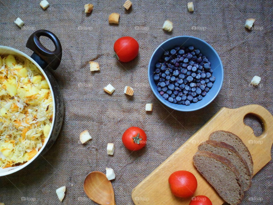 stewed potatoes, frozen currants, bread, tomatoes on the table