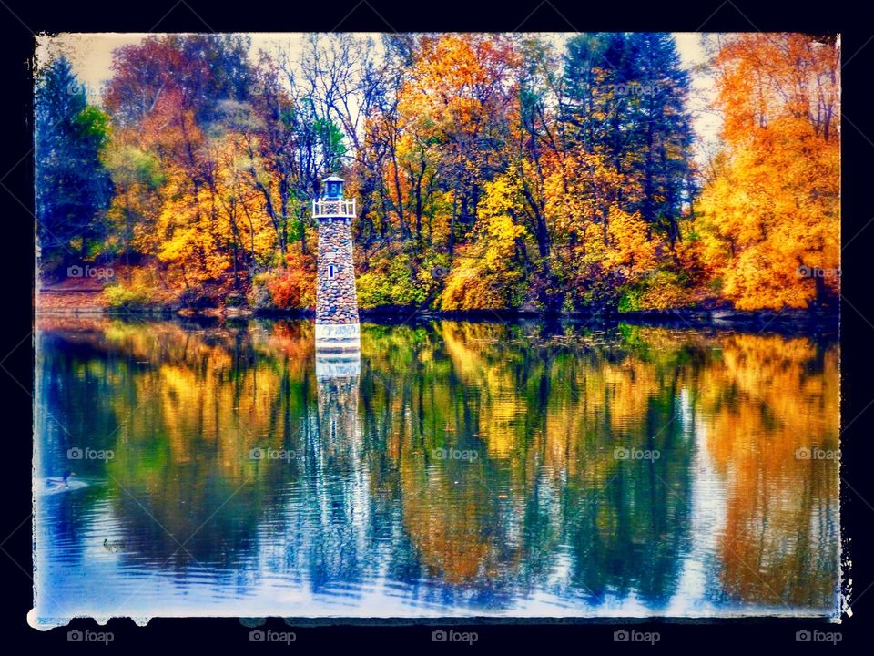 Fall lighthouse in the pond