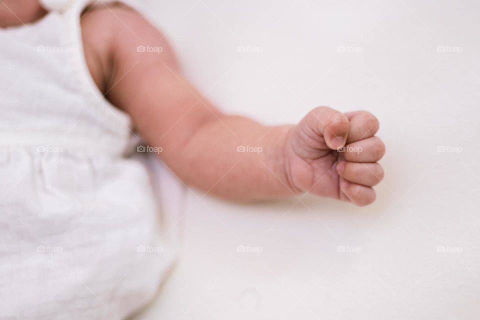 Amazing close up of newborn’s little hand in a fist. Detailing the delicate fingers and skin of a precious, newborn baby.