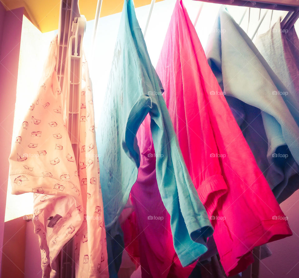 close up of colored drying clothes view from below