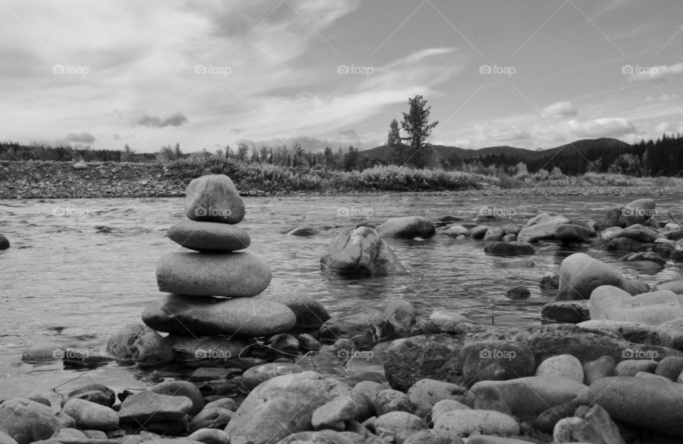 Stones piled at the edge of a river in Kananaskis country, Alberta