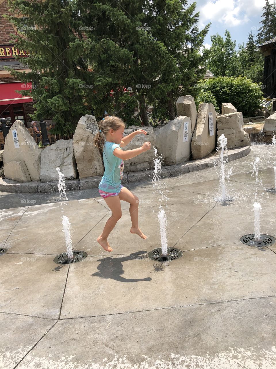 Jumping through the sprays at the Water Park