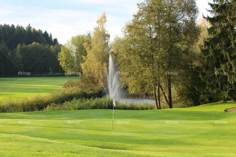 Golf course flag near fountain