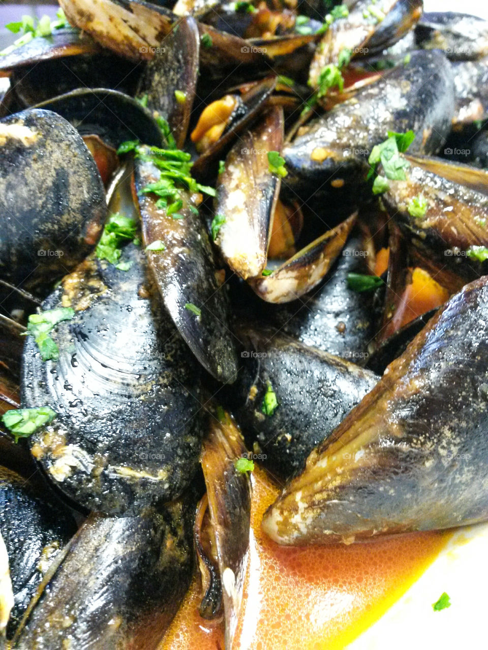 French cuisine: Close up of 'moules sautè avec pomme de terre'. mussels with tomato sauce