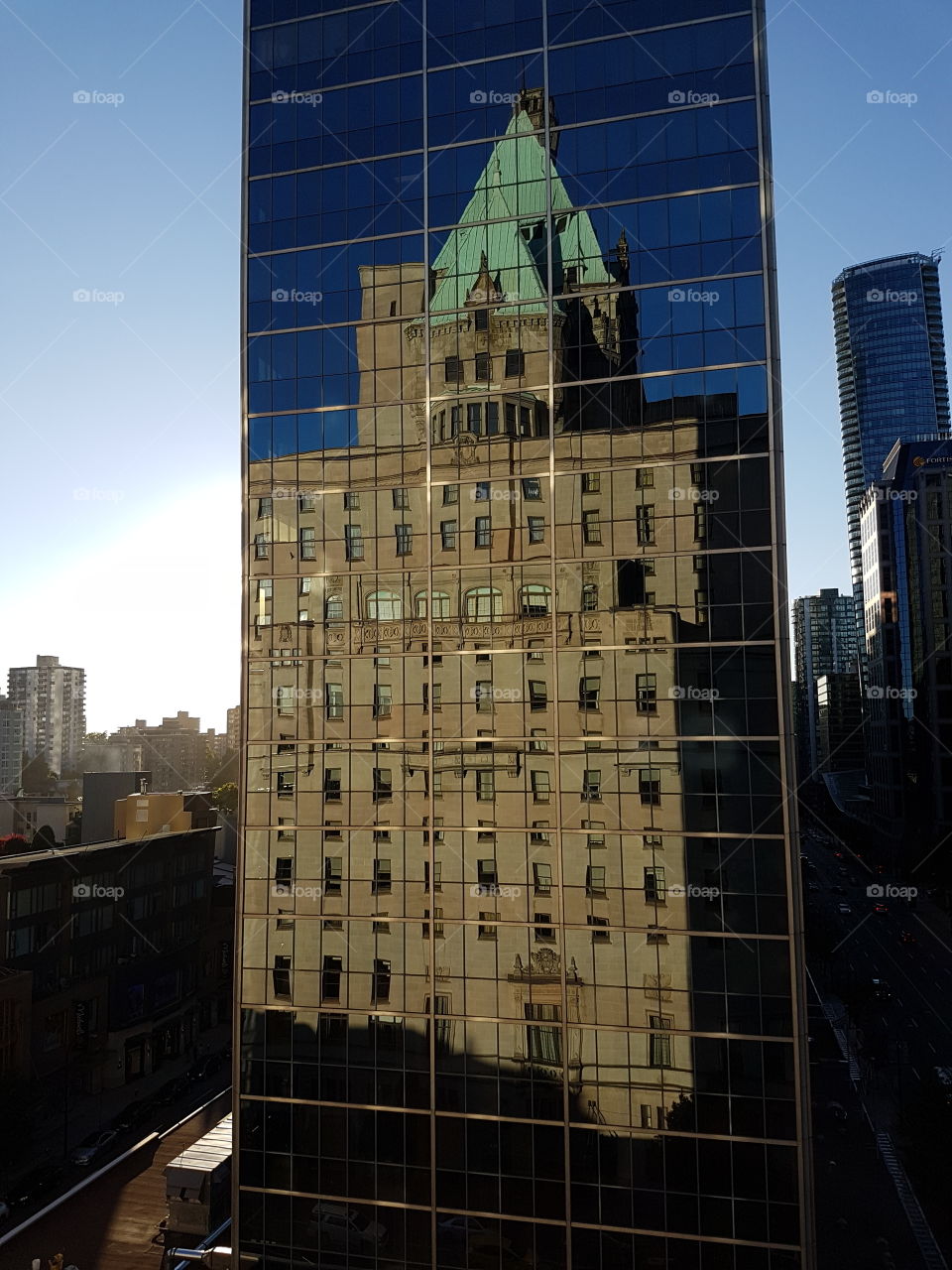 Mirror reflection of The Castle Fairmont hotel in next door building, Vancouver Canada