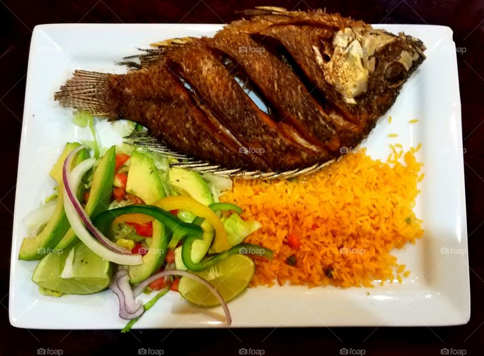 Whole fried fish with fried rice and vegetable