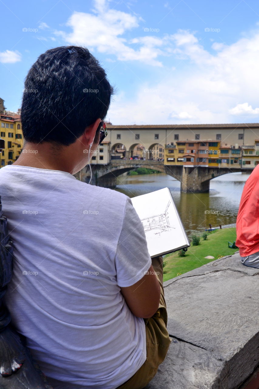 a young artist draws a landscape