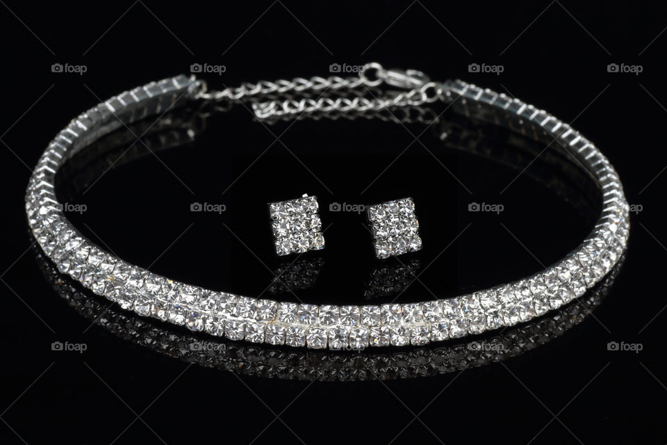 Modern diamond jewelry set on black background