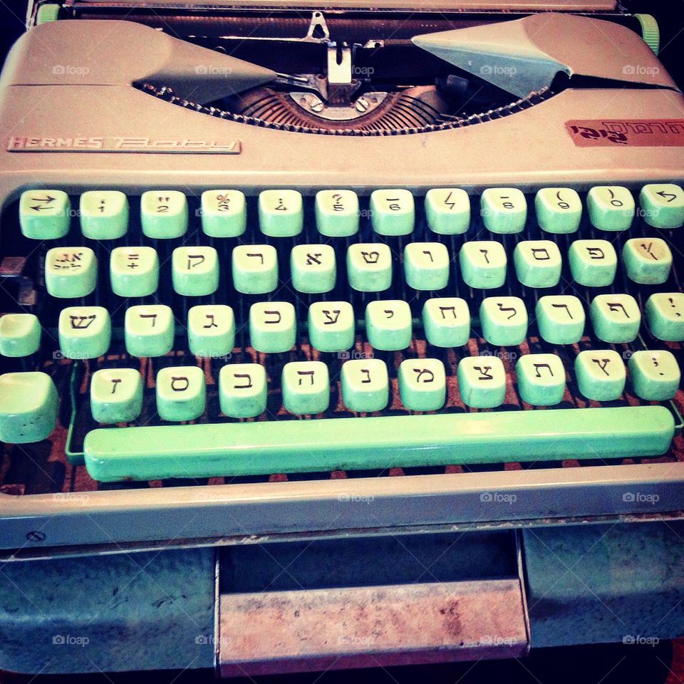Old typewriter with Hebrew letters, in old green ,abc in Hebrew, photo taken in a fleet market in old Jaffa 