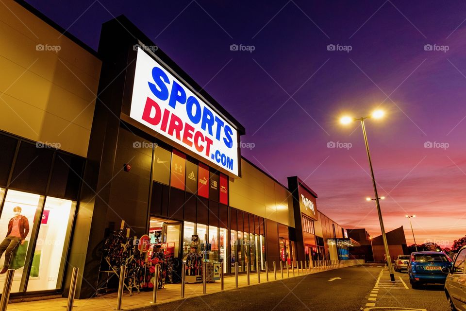 Modern UK Sports Direct store at sunset