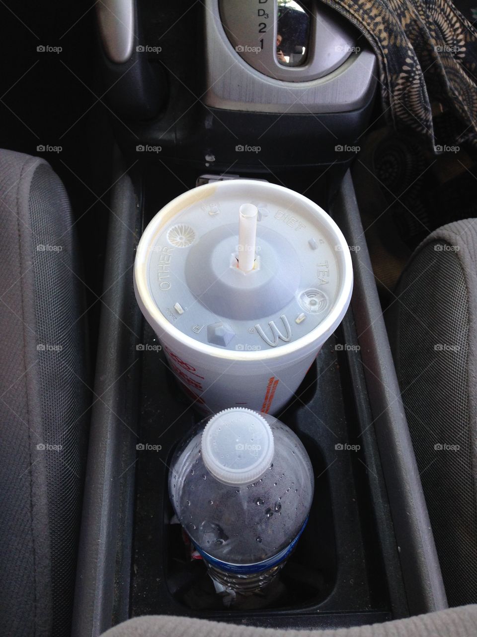 Drinks in the cup holders between the two front car seats.