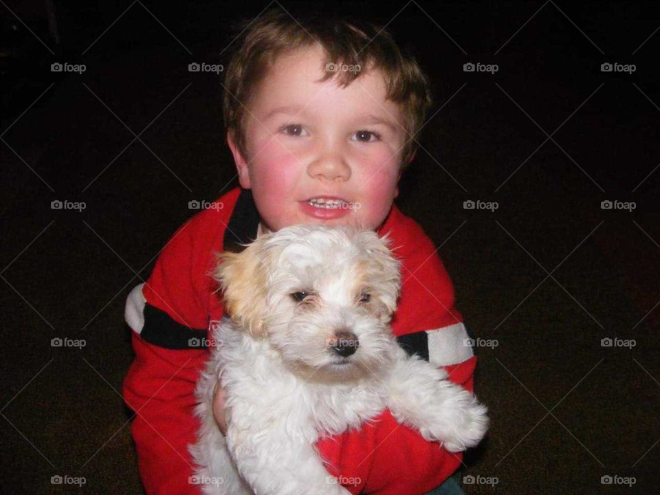 Two sweet little boys together. Sharing fun times love and companionship. Teach children compassion by letting them care for a dog.