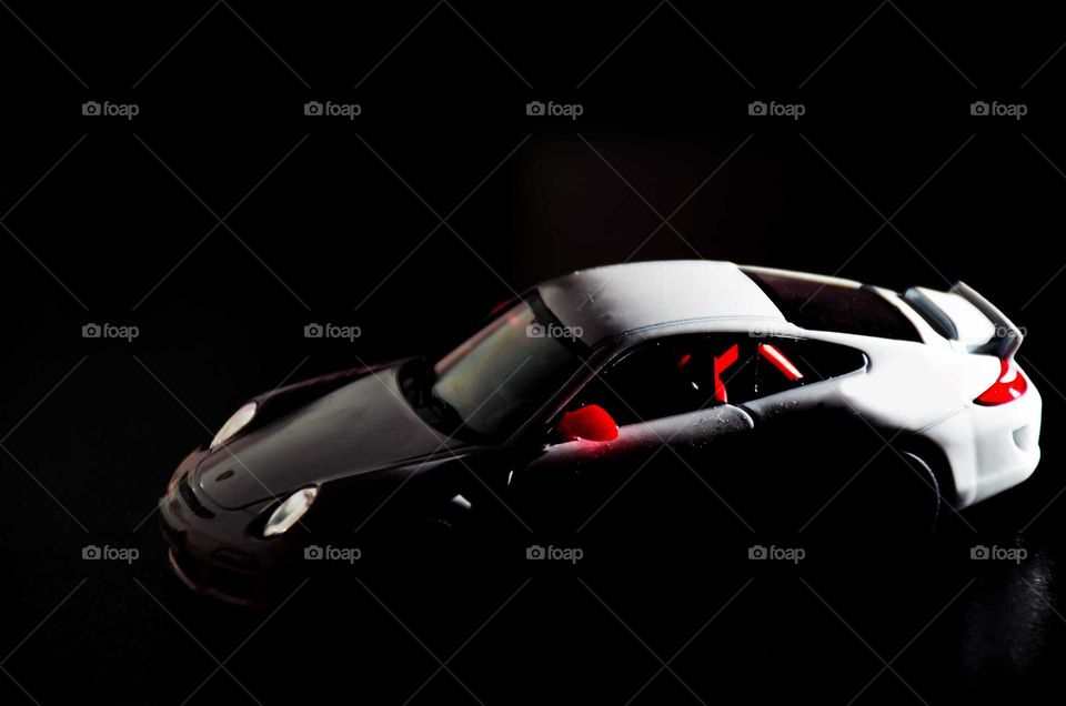 small toy car on black background