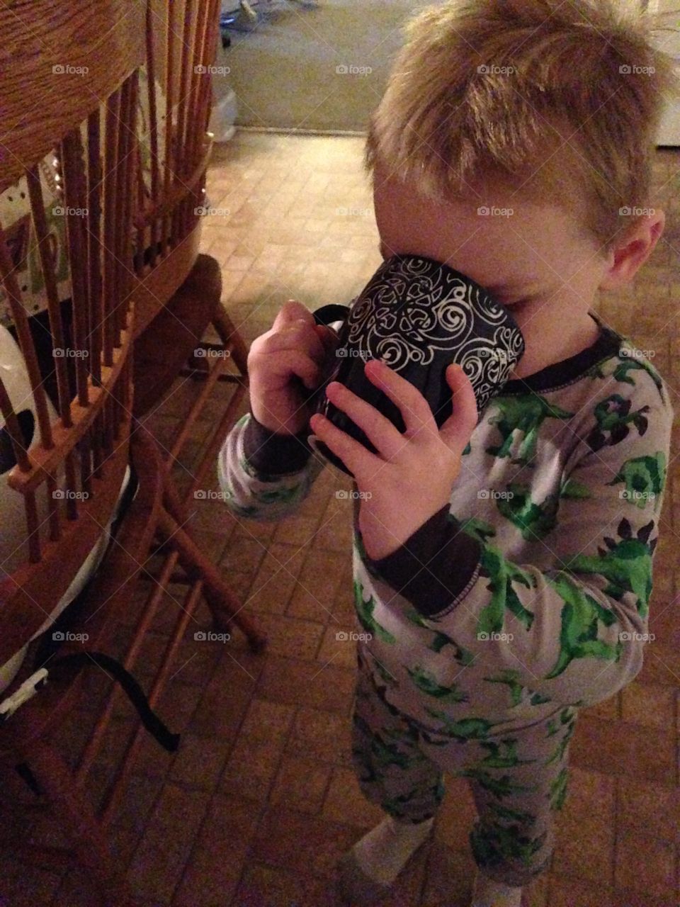 Close-up of a boy drinking cup of coffee