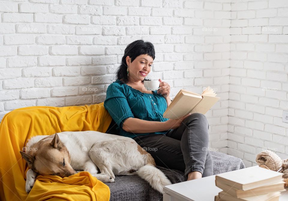 Woman Drinking Book at home