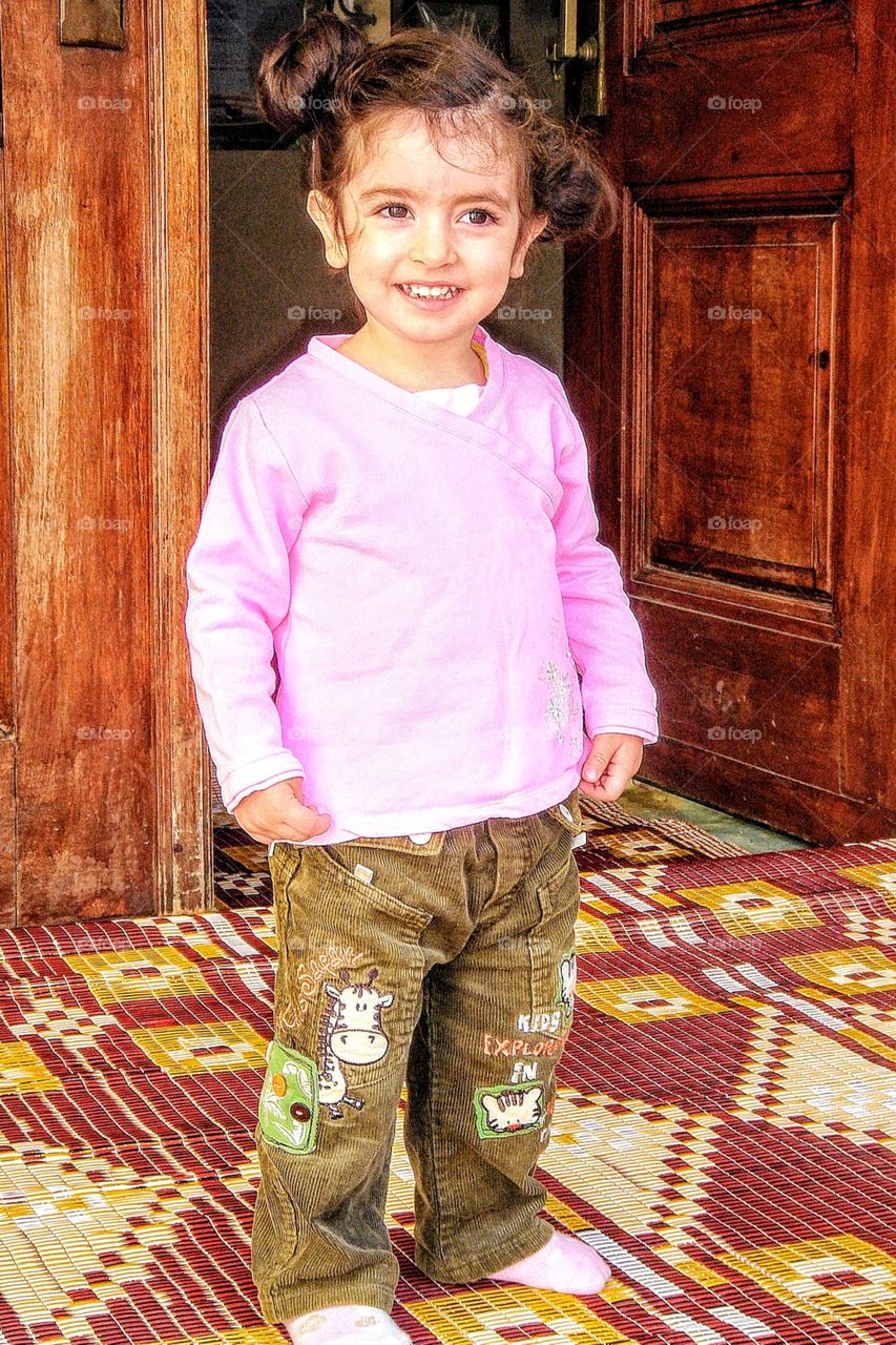 Pretty little girl at entrance to Turkish mosque