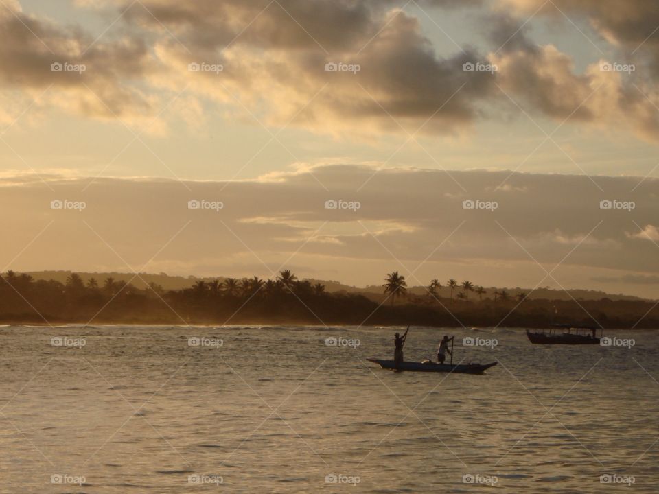 Calm Evening. A boat passes by at Itacaré beach in Bahia, Brazil 