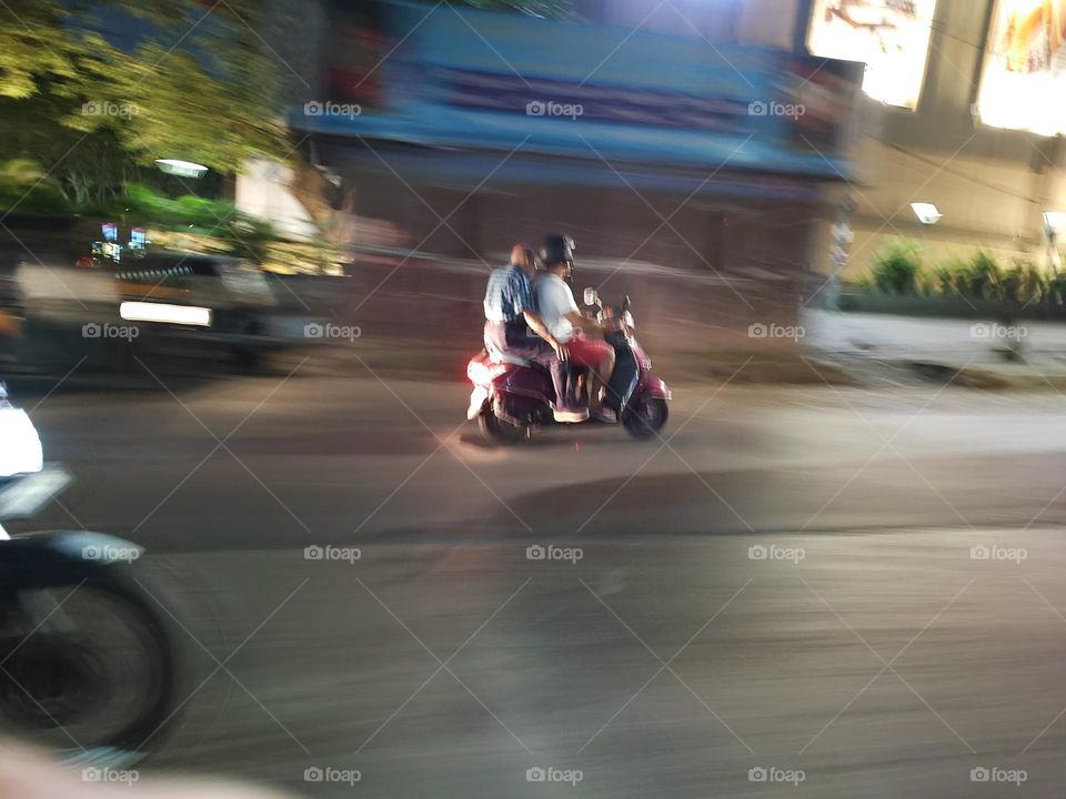 Two riders on a sleek motorcycle, wind in their hair, zooming down the open road with exhilaration, embodying freedom and adventure.