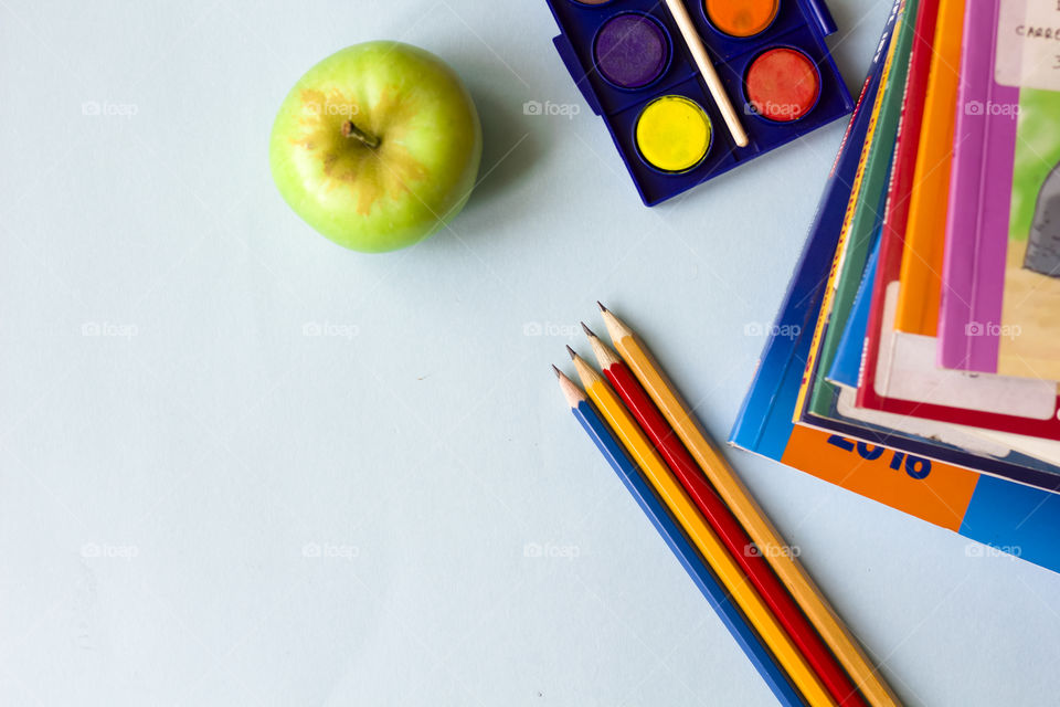 pencils apple and books