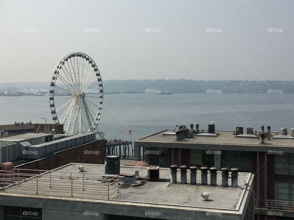 A Ferris wheel behind buildings in Seattle
