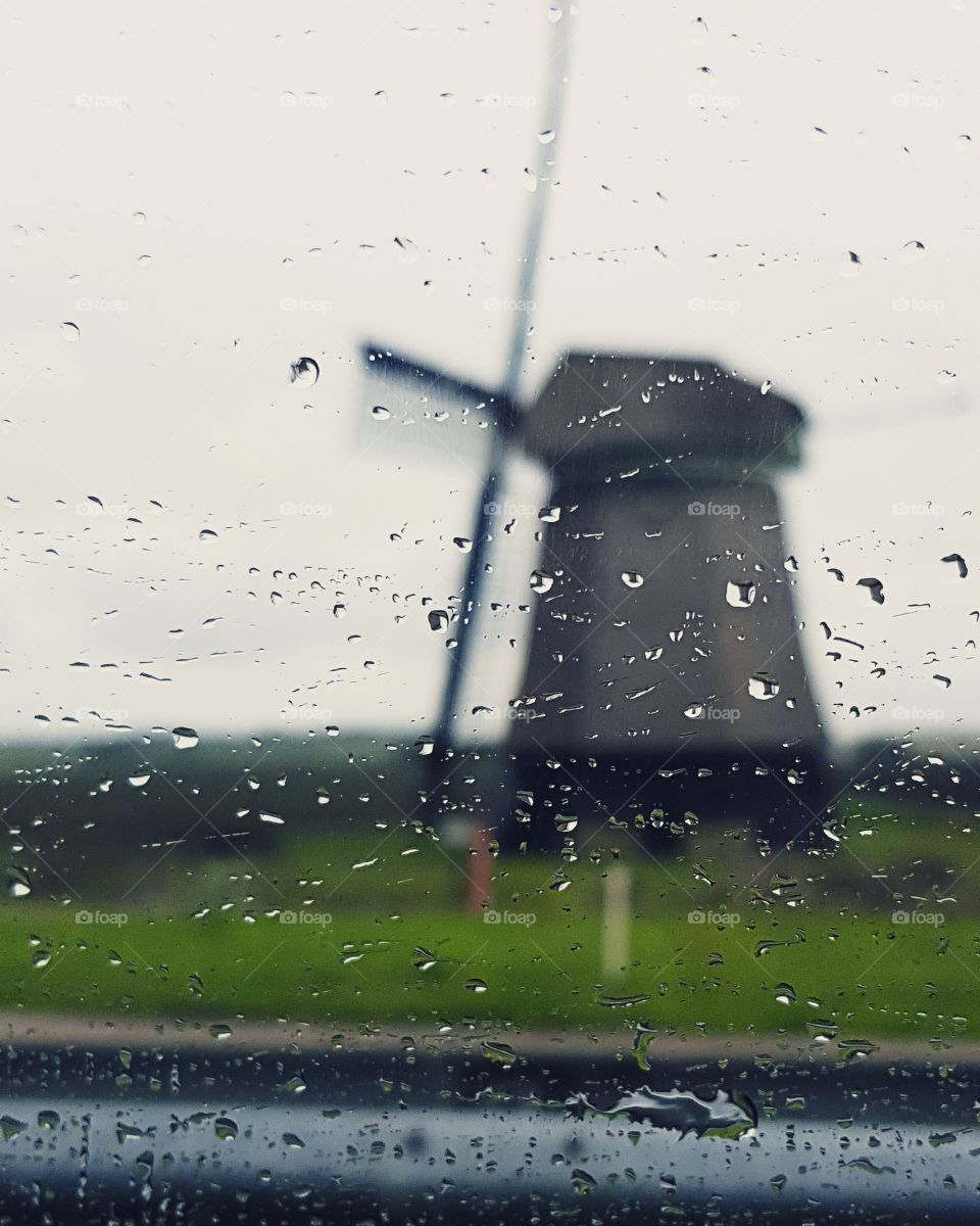 windmill behind the rainy window