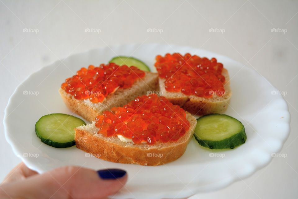 sandwiches with red caviar on a plate