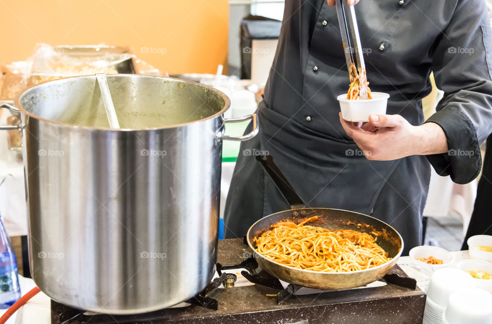 Chef In The Hotel Kitchen Restaurant Serving Pasta Macaroni
