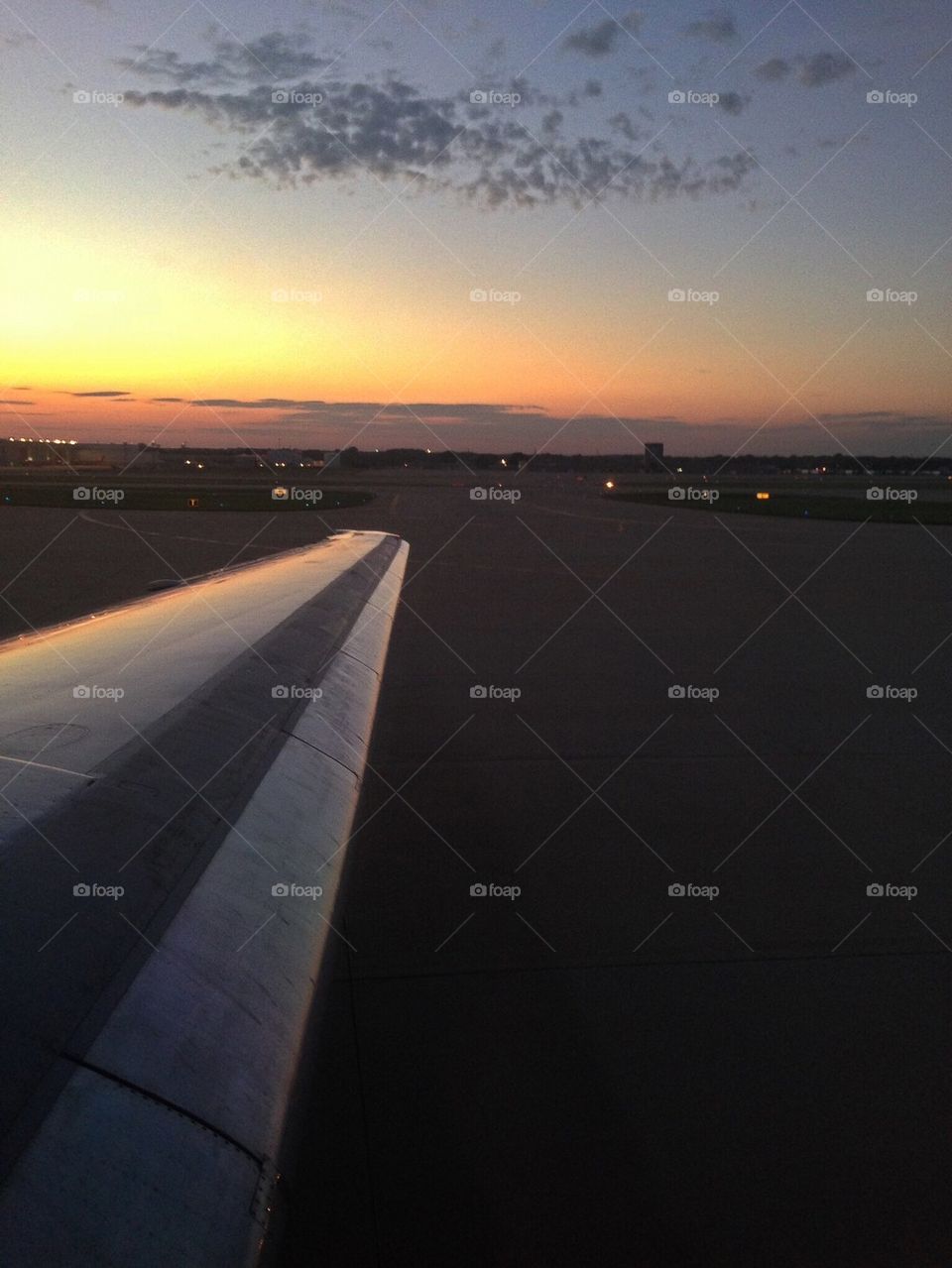 Airplane wing at sunset