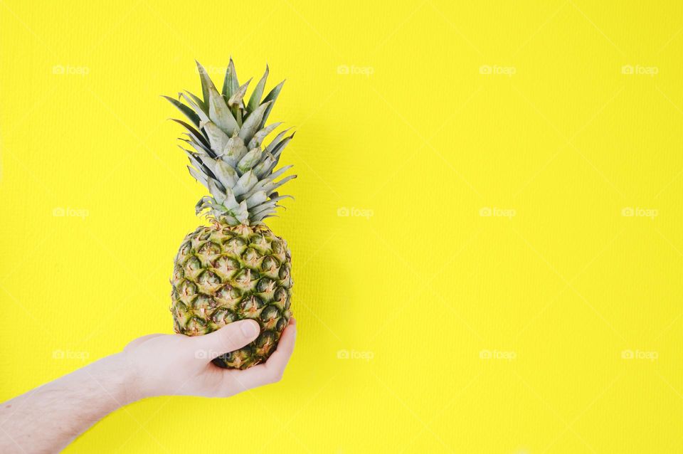 A pineapple on yellow background 