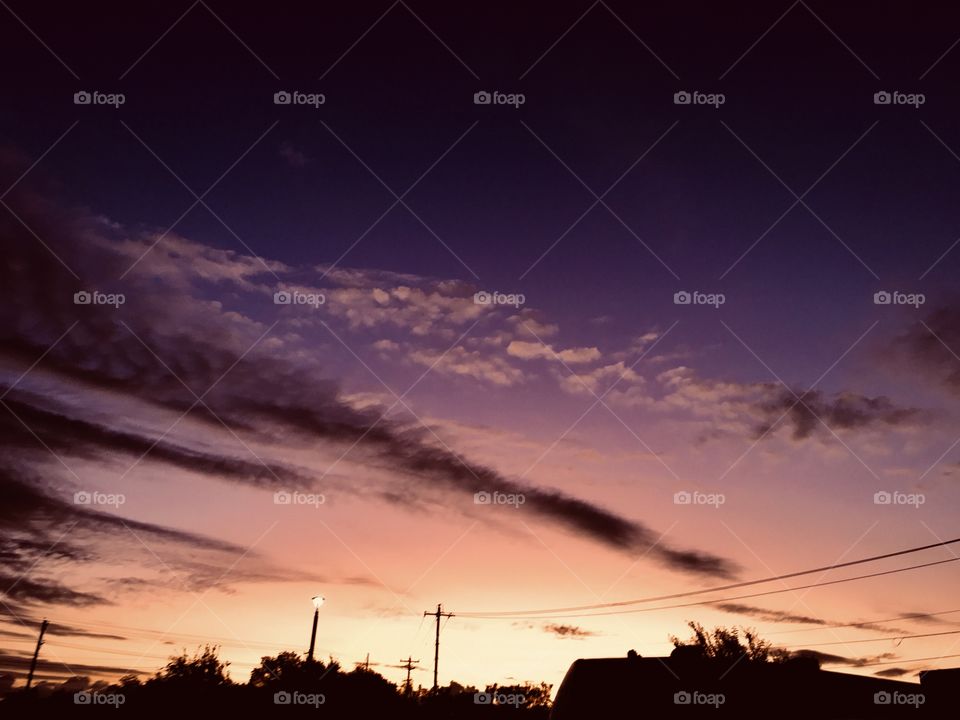 Disappearing Night giving way to Sunrise morning. Whispering Clouds moving in ever so slowly enhances morning colors of multiple of shades.