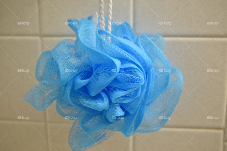Blue loufa hanging in shower