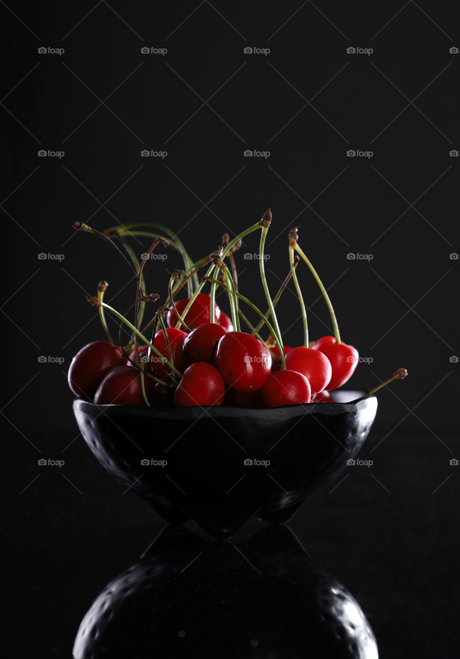Fresh Red Cherries in black bowl