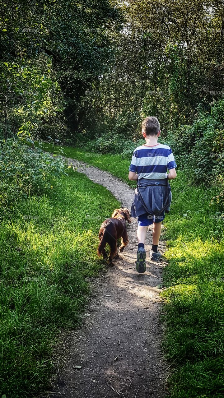 Boy and his dog on a late Summer walk in Staffordshire, England.