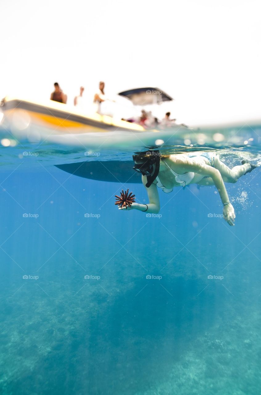 A woman swimming with reef 