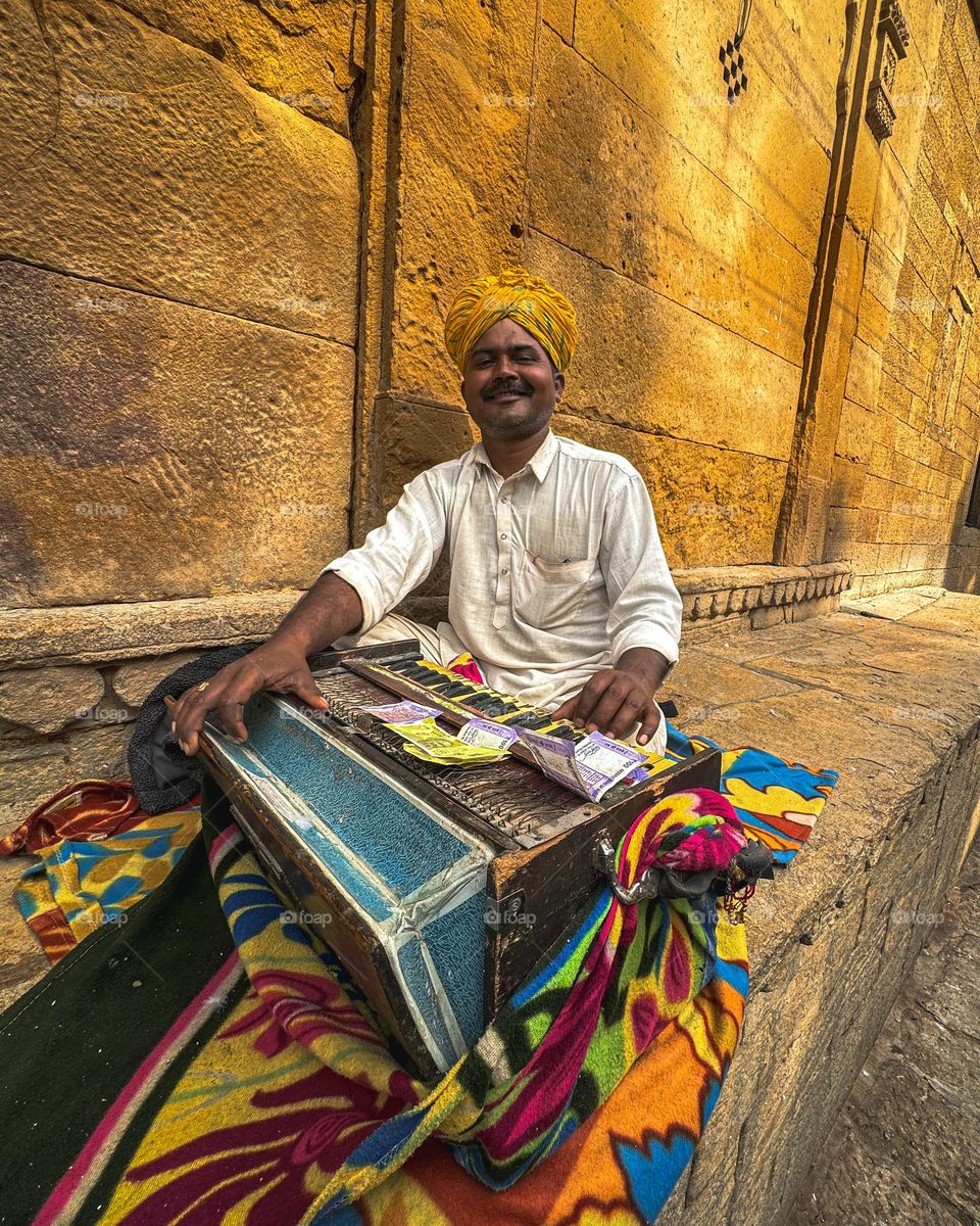 An artistic musician playing traditional melodies in the jaisalmer fort