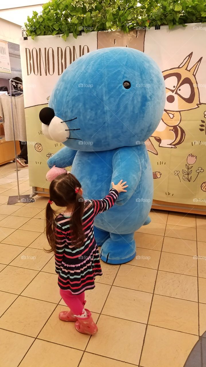 Little girl playing with cartoon character