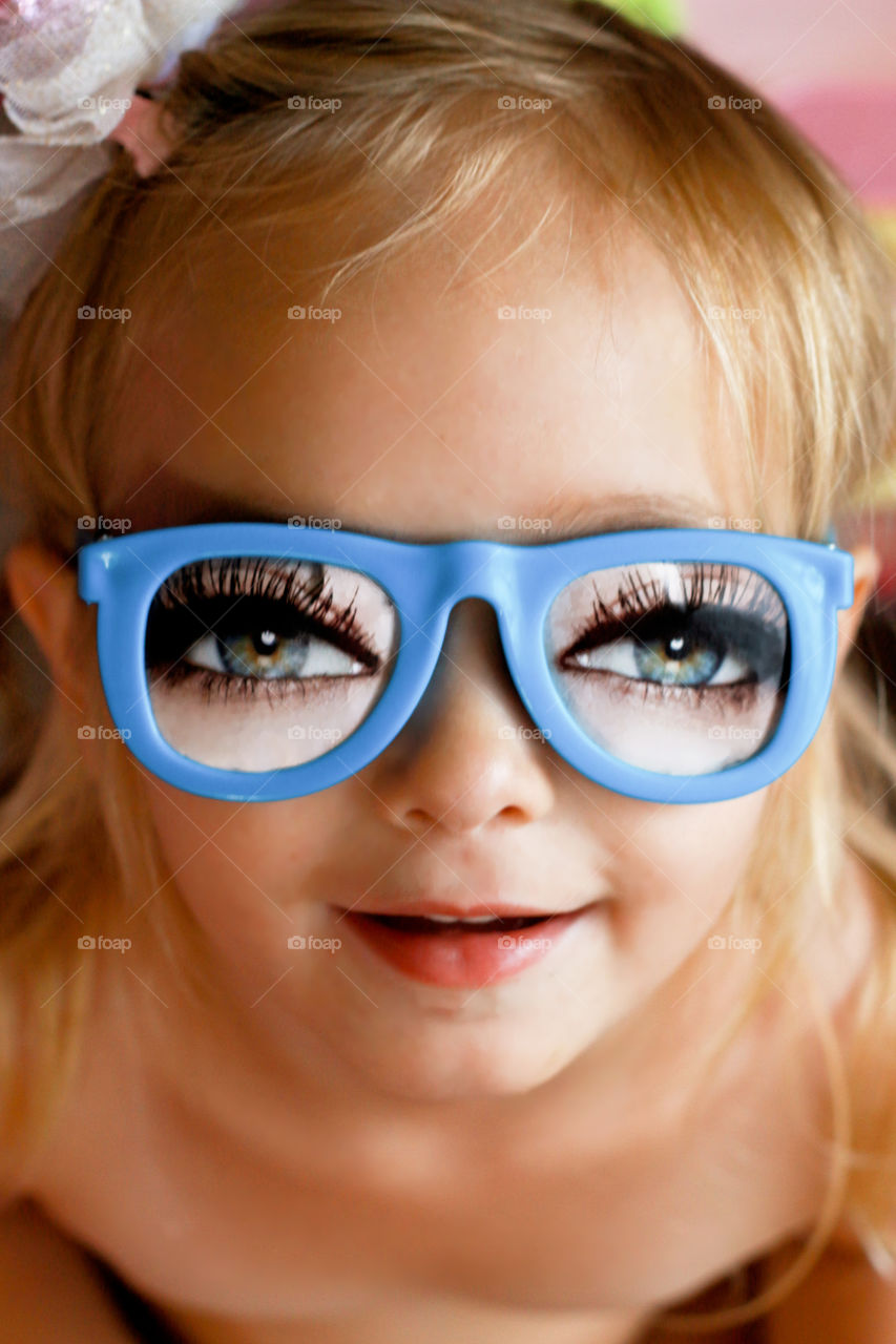 Close-up of a girl with funny eyeglasses