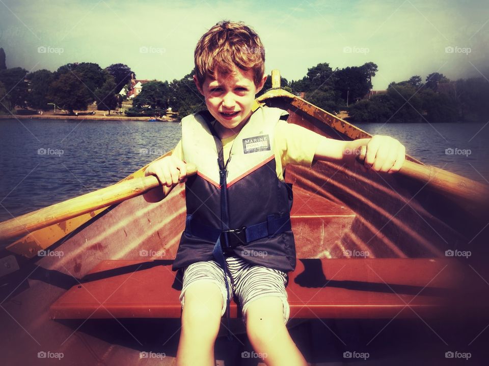 Seven year old. It rowing a boat